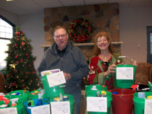 Advisory Council giving buckets of household products to WeCan